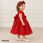 Baby girl wearing the Red Baby Floral Rosette Dress D-1664, right side view.