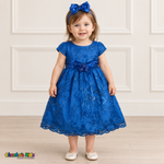 Baby girl wearing the Royal Blue Baby Floral Rosette Dress D-1664, front view with matching bow headband.