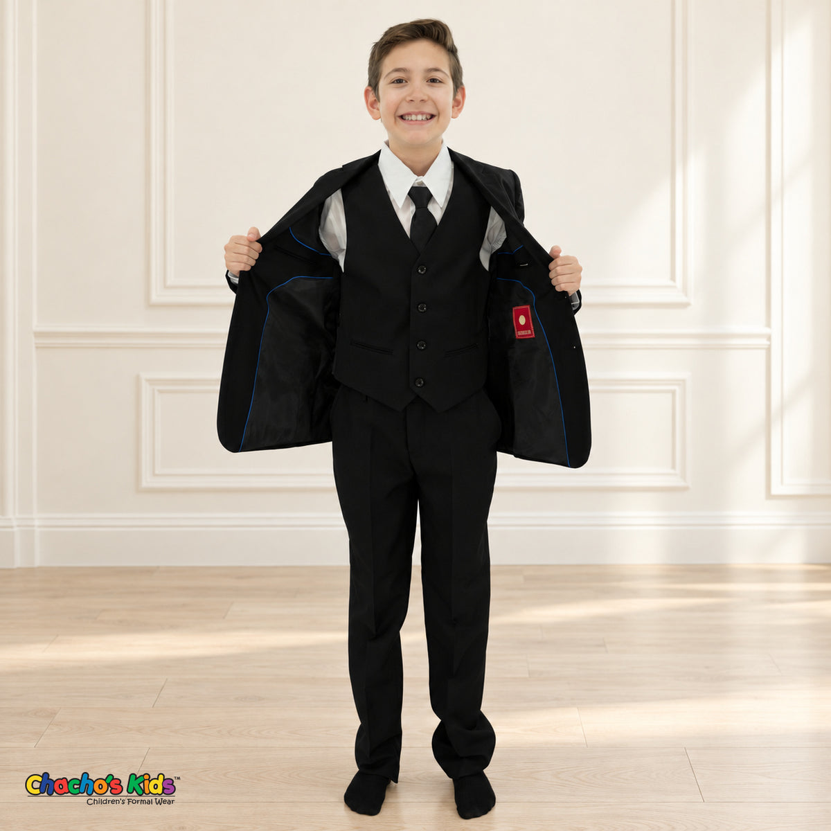Black BJ4005 Executive boys suit on the existing child model, open-jacket view showing the button-front vest, original black lining and blue piping.