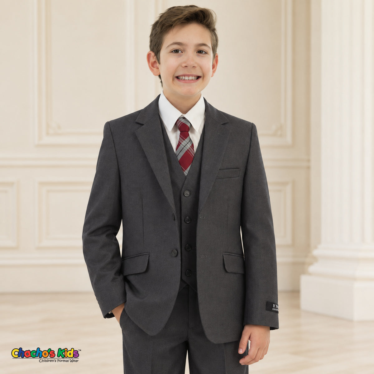 Charcoal Gray BJ4005 Premium Executive boys suit on the existing child model, front portrait with coat, vest, white shirt and red-and-gray plaid tie.