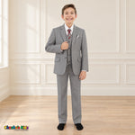 Gray BJ4005 Premium Executive boys suit on the existing child model, full front view with white shirt, patterned tie and coordinating dotted pocket square.