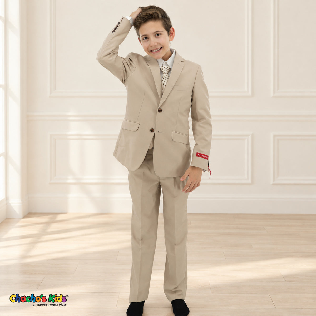 Khaki BJ4005 Premium Executive boys suit, hand raised front view with matching coat and vest, white shirt and light dotted tie.