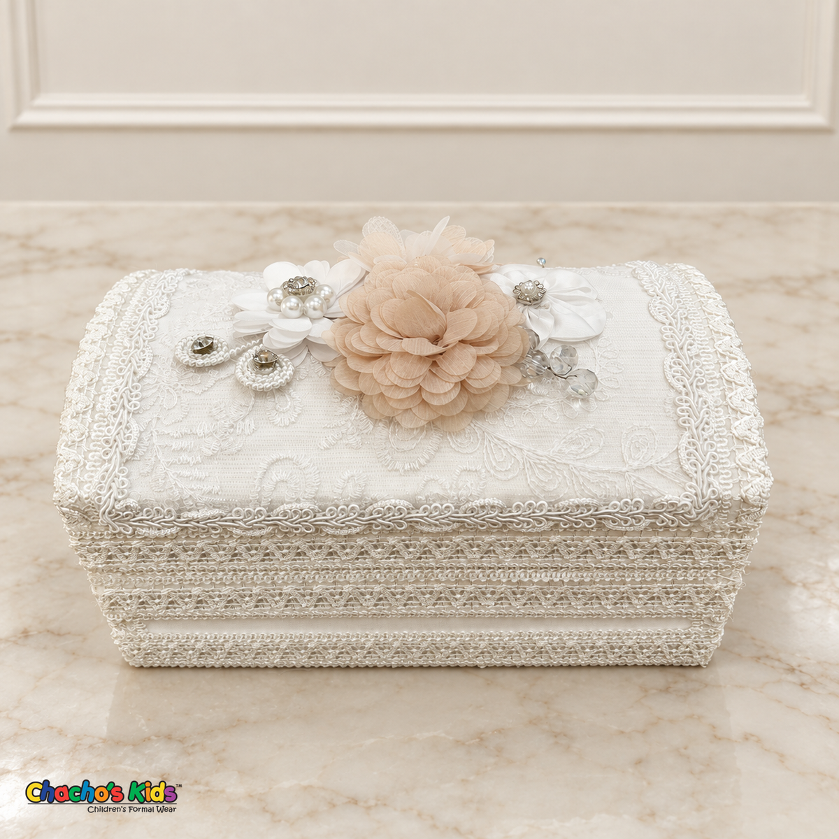 Long white baptism keepsake chest with champagne and white flowers, pearl accents and decorative lace.
