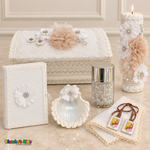 Seven-piece champagne and white floral baptism set with long keepsake chest, lit candle, white Bible, shell, rosary jar, white handkerchief and visible scapular.
