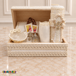 Cream ivory seven-piece baptism chest set with candle, Bible, shell, gold-tone rosary, handkerchief and unbagged scapular arranged inside the open wooden chest