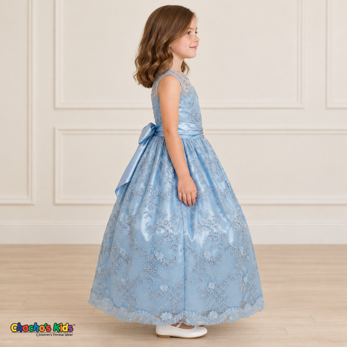 Girl wearing the Baby Blue Floral Embroidered Dress, Style D1550, side view, showing the sleeveless silhouette, floral embroidery and scalloped skirt.