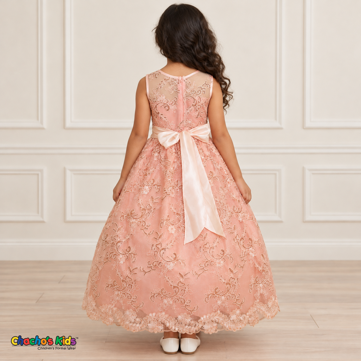 Girl wearing the Blush Floral Embroidered Dress, Style D1550, back view, showing the embroidered sheer back, zipper and satin bow.