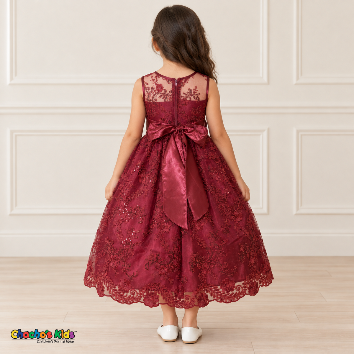 Girl wearing the Burgundy Floral Embroidered Dress, Style D1550, back view, showing the embroidered sheer back, zipper and satin bow.