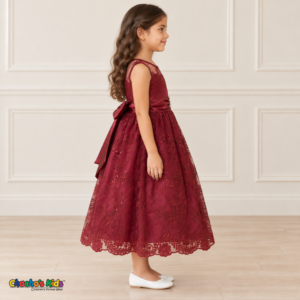 Girl wearing the Burgundy Floral Embroidered Dress, Style D1550, side view, showing the sleeveless silhouette, floral embroidery and scalloped skirt.