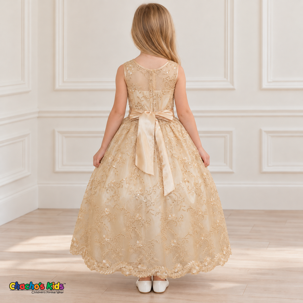 Girl wearing the Champagne Floral Embroidered Dress, Style D1550, back view, showing the embroidered sheer back, zipper and satin bow.