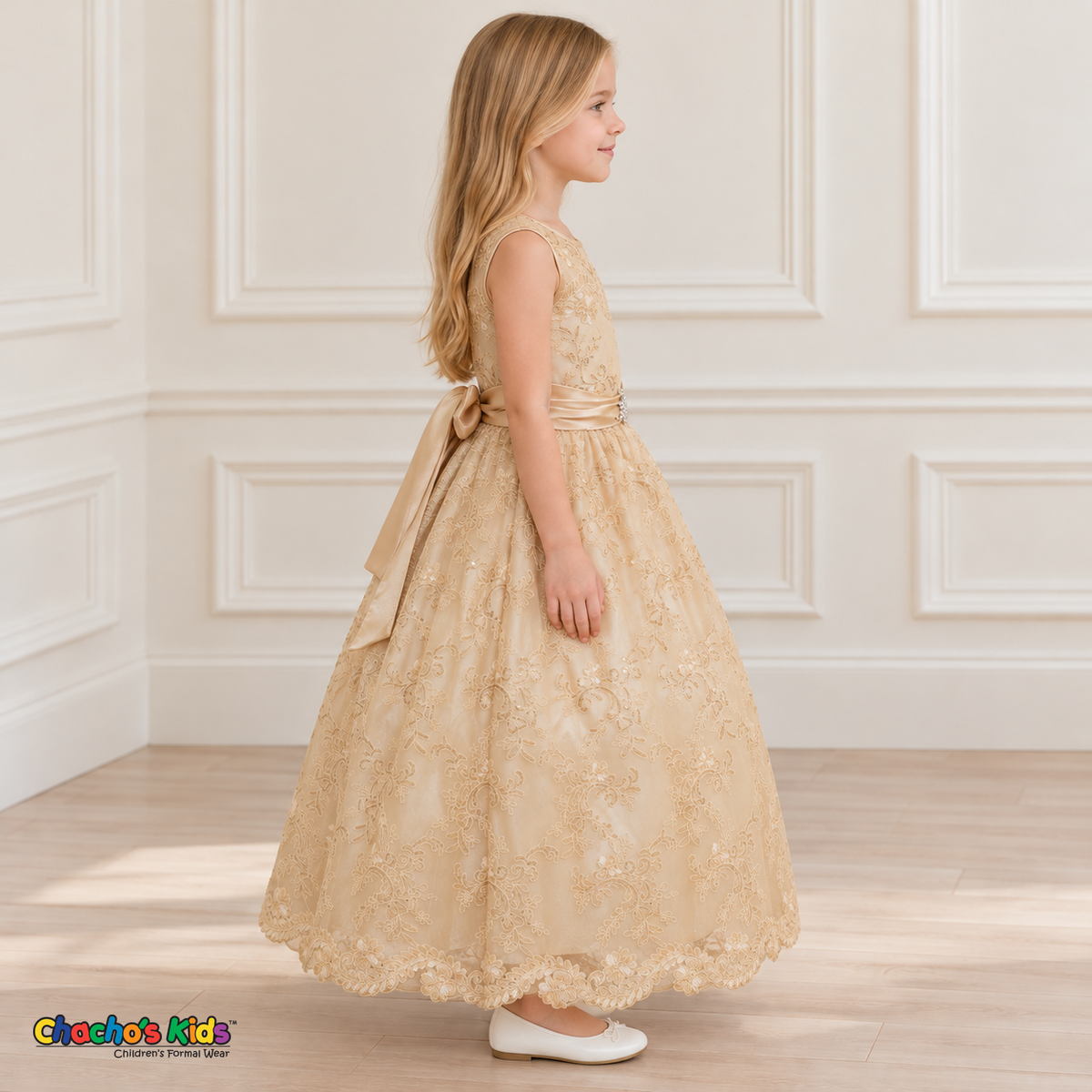 Girl wearing the Champagne Floral Embroidered Dress, Style D1550, side view, showing the sleeveless silhouette, floral embroidery and scalloped skirt.