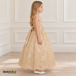 Girl wearing the Champagne Floral Embroidered Dress, Style D1550, side view, showing the sleeveless silhouette, floral embroidery and scalloped skirt.