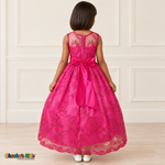Girl wearing the Fuchsia Floral Embroidered Dress, Style D1550, back view, showing the embroidered sheer back, zipper and satin bow.
