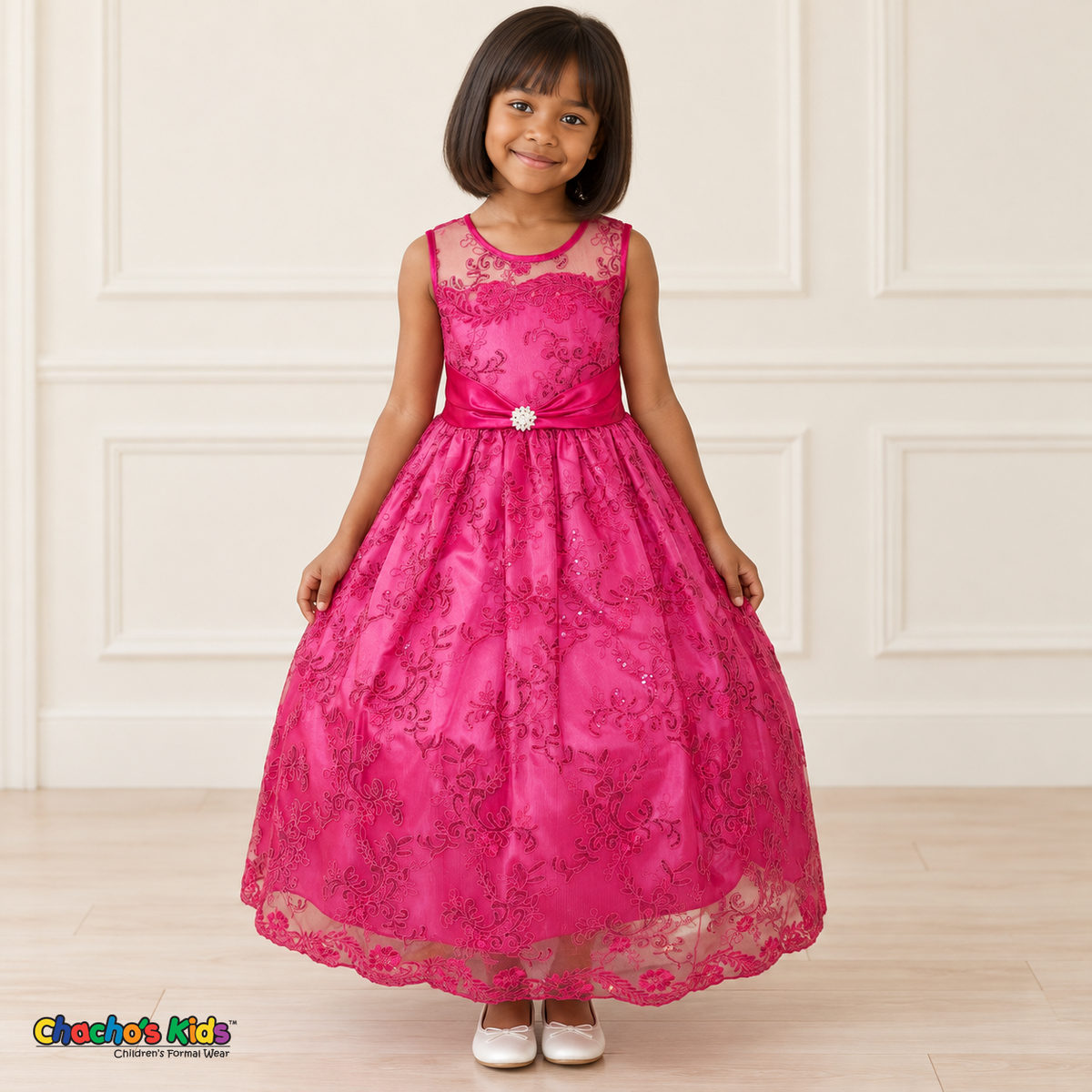 Girl wearing the Fuchsia Floral Embroidered Dress, Style D1550, front view, showing floral embroidery, a sheer neckline and a decorated satin sash.