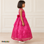 Girl wearing the Fuchsia Floral Embroidered Dress, Style D1550, side view, showing the sleeveless silhouette, floral embroidery and scalloped skirt.