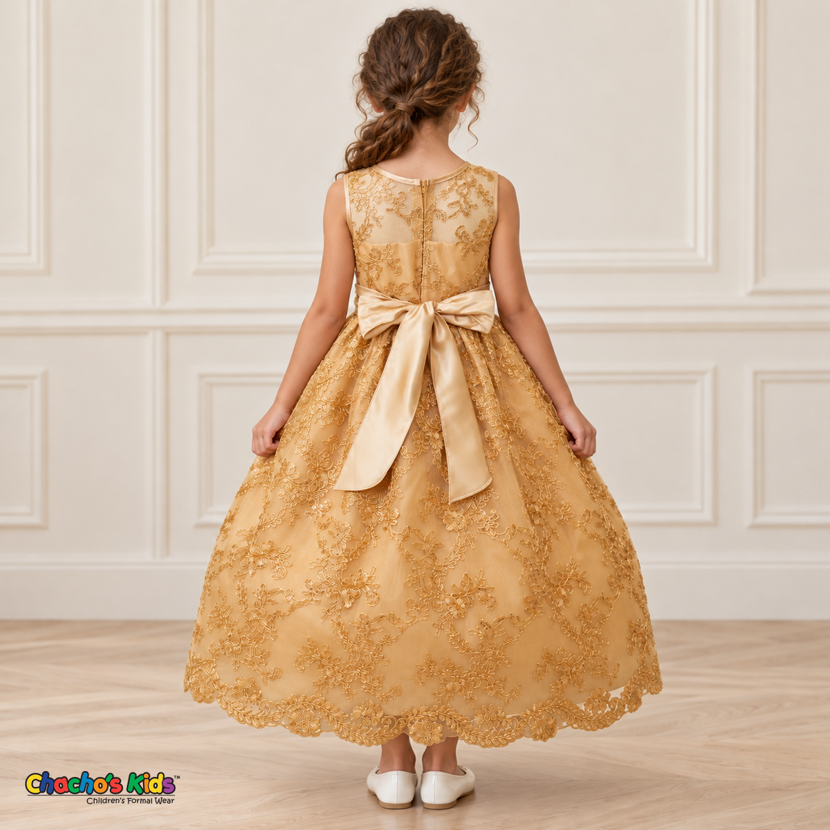 Girl wearing the Gold Floral Embroidered Dress, Style D1550, back view, showing the embroidered sheer back, zipper and satin bow.