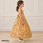 Girl wearing the Gold Floral Embroidered Dress, Style D1550, side view, showing the sleeveless silhouette, floral embroidery and scalloped skirt.