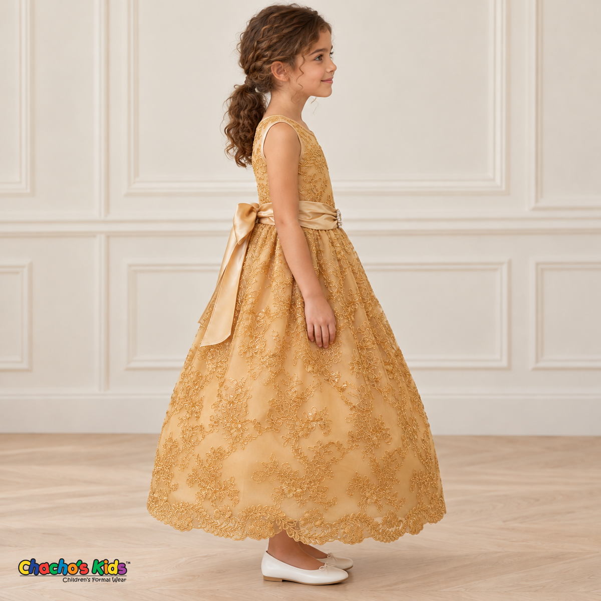 Girl wearing the Gold Floral Embroidered Dress, Style D1550, side view, showing the sleeveless silhouette, floral embroidery and scalloped skirt.