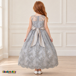 Girl wearing the Gray Floral Embroidered Dress, Style D1550, back view, showing the embroidered sheer back, zipper and satin bow.