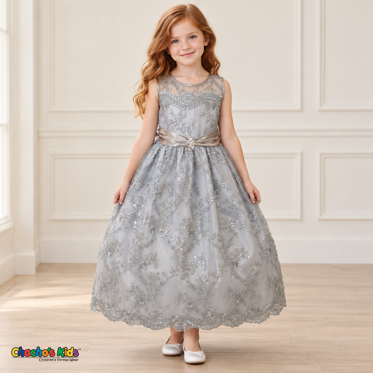 Girl wearing the Gray Floral Embroidered Dress, Style D1550, front view, showing floral embroidery, a sheer neckline and a decorated satin sash.