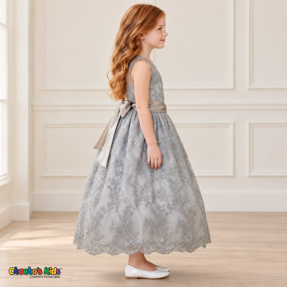 Girl wearing the Gray Floral Embroidered Dress, Style D1550, side view, showing the sleeveless silhouette, floral embroidery and scalloped skirt.
