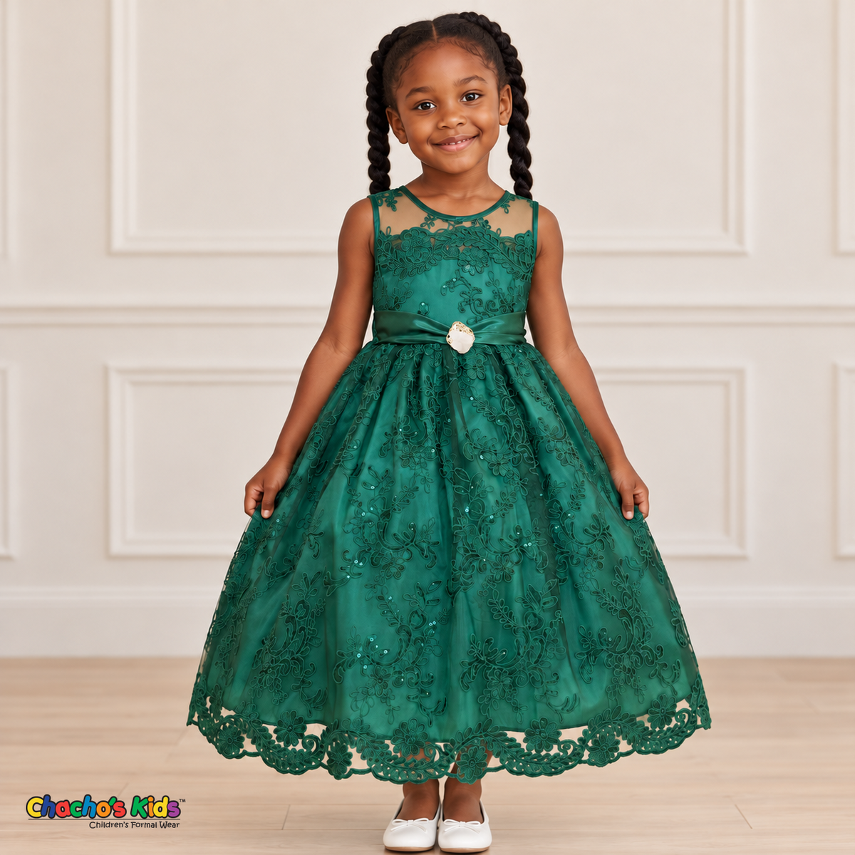 Girl wearing the Hunter Green Floral Embroidered Dress, Style D1550, front view, showing floral embroidery, a sheer neckline and a decorated satin sash.