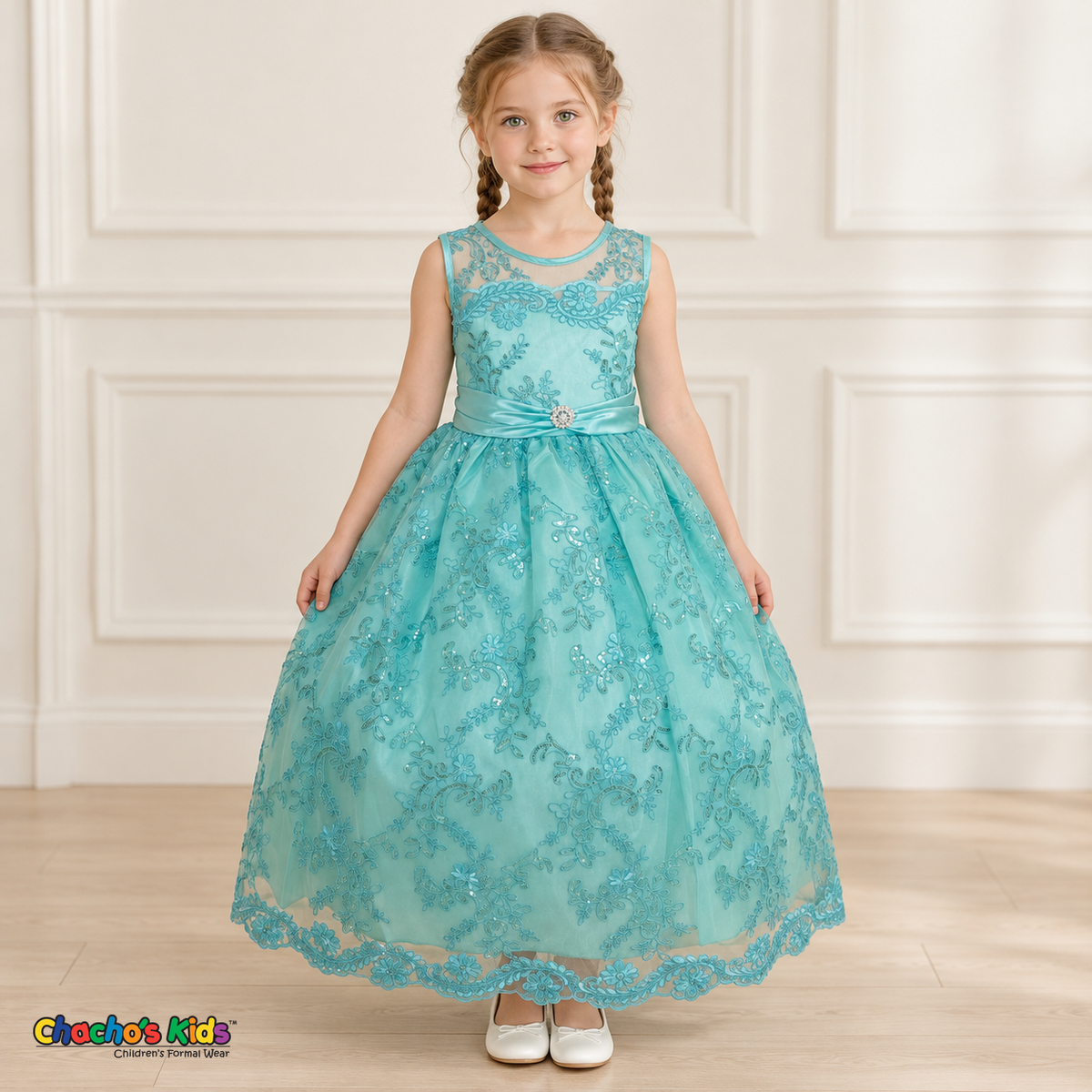 Girl wearing the Mint Green Floral Embroidered Dress, Style D1550, front view, showing floral embroidery, a sheer neckline and a decorated satin sash.