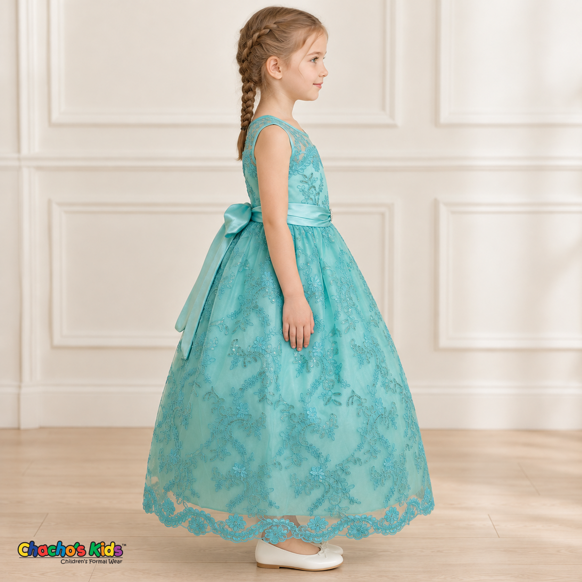 Girl wearing the Mint Green Floral Embroidered Dress, Style D1550, side view, showing the sleeveless silhouette, floral embroidery and scalloped skirt.