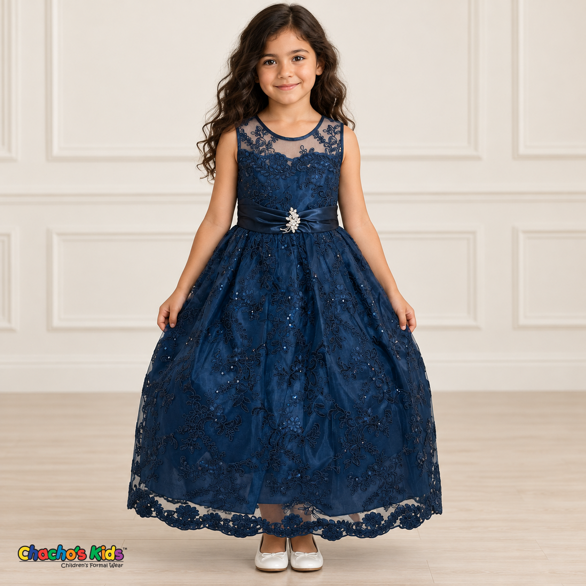 Girl wearing the Navy Blue Floral Embroidered Dress, Style D1550, front view, showing floral embroidery, a sheer neckline and a decorated satin sash.
