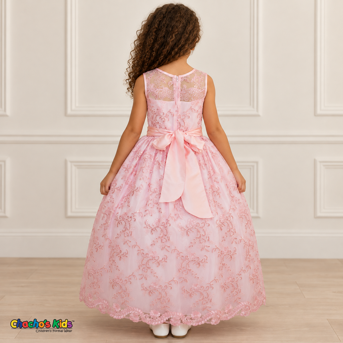Girl wearing the Pink Floral Embroidered Dress, Style D1550, back view, showing the embroidered sheer back, zipper and satin bow.