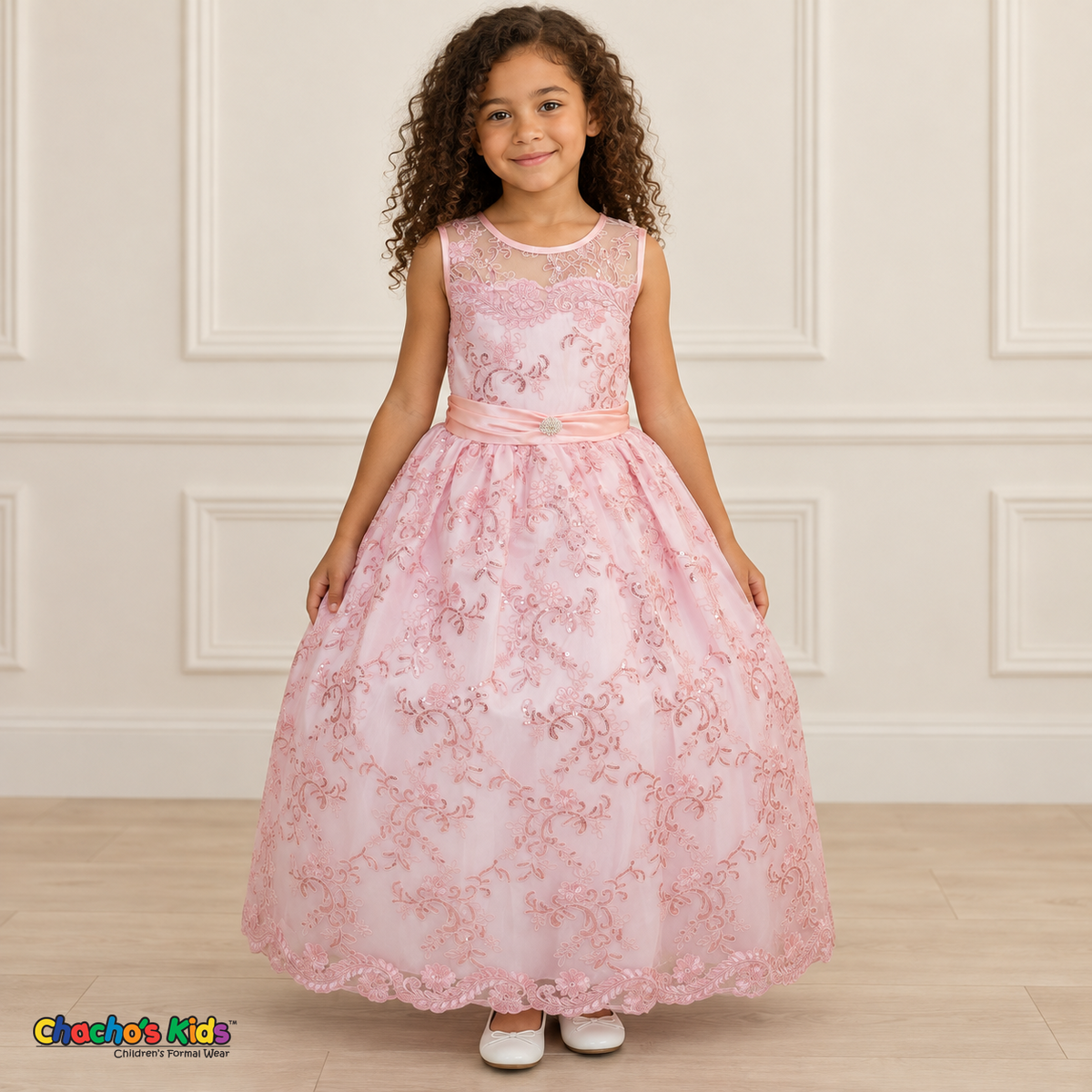Girl wearing the Pink Floral Embroidered Dress, Style D1550, front view, showing floral embroidery, a sheer neckline and a decorated satin sash.