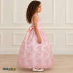 Girl wearing the Pink Floral Embroidered Dress, Style D1550, side view, showing the sleeveless silhouette, floral embroidery and scalloped skirt.