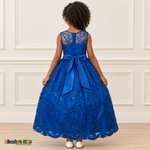 Girl wearing the Royal Blue Floral Embroidered Dress, Style D1550, back view, showing the embroidered sheer back, zipper and satin bow.