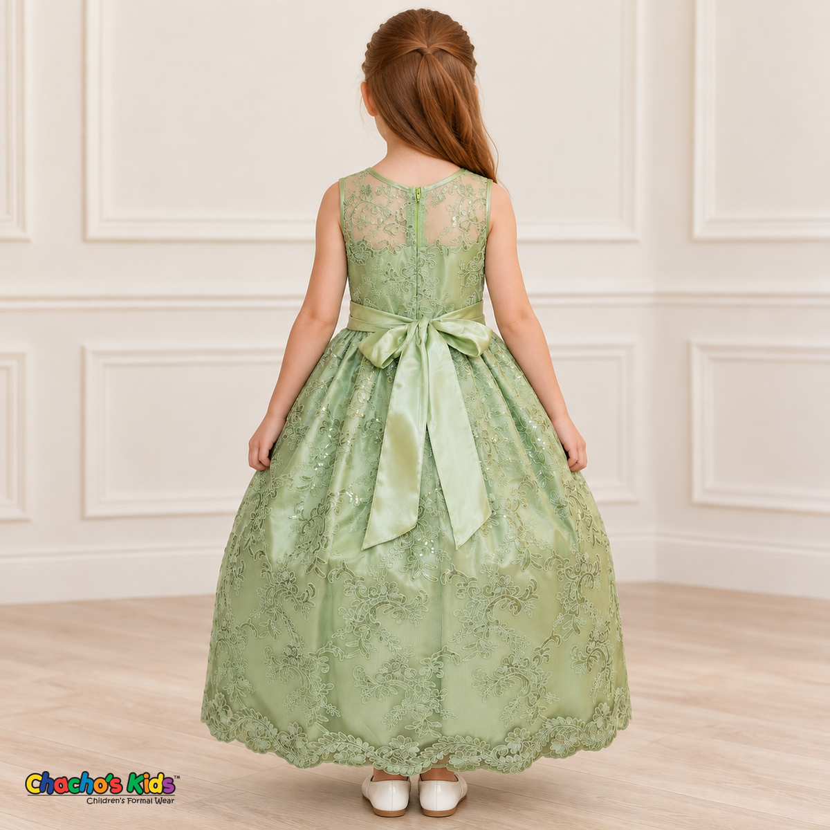 Girl wearing the Sage Green Floral Embroidered Dress, Style D1550, back view, showing the embroidered sheer back, zipper and satin bow.
