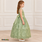 Girl wearing the Sage Green Floral Embroidered Dress, Style D1550, side view, showing the sleeveless silhouette, floral embroidery and scalloped skirt.