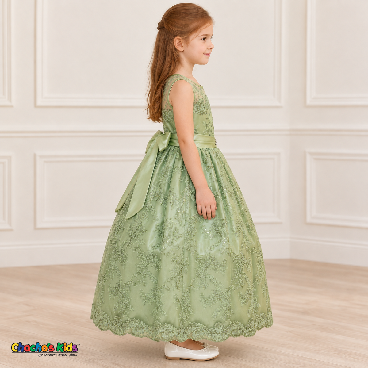 Girl wearing the Sage Green Floral Embroidered Dress, Style D1550, side view, showing the sleeveless silhouette, floral embroidery and scalloped skirt.