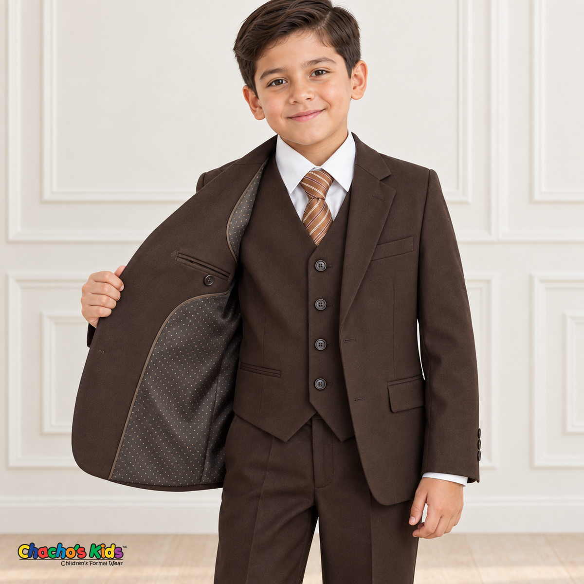 Boy holding his brown suit coat open to show the fine dotted interior lining and inside pocket.
