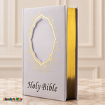Large English Holy Bible with white cover and gold details — front view with blank portrait window and reflective page edges