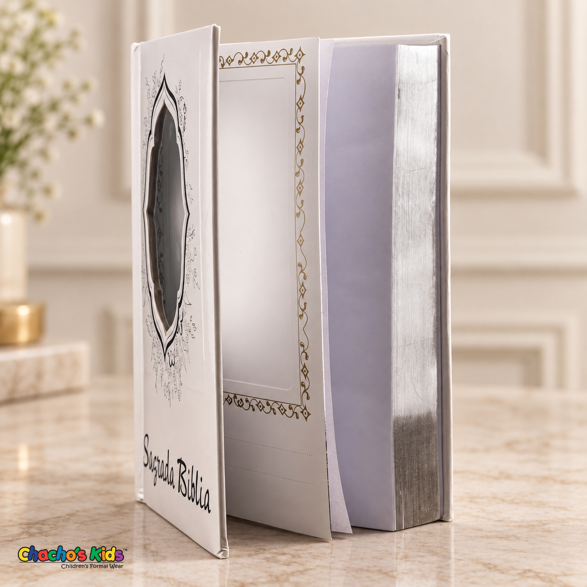 Large Spanish Holy Bible with white cover and silver details — open view showing the interior photo pocket and reflective page edges