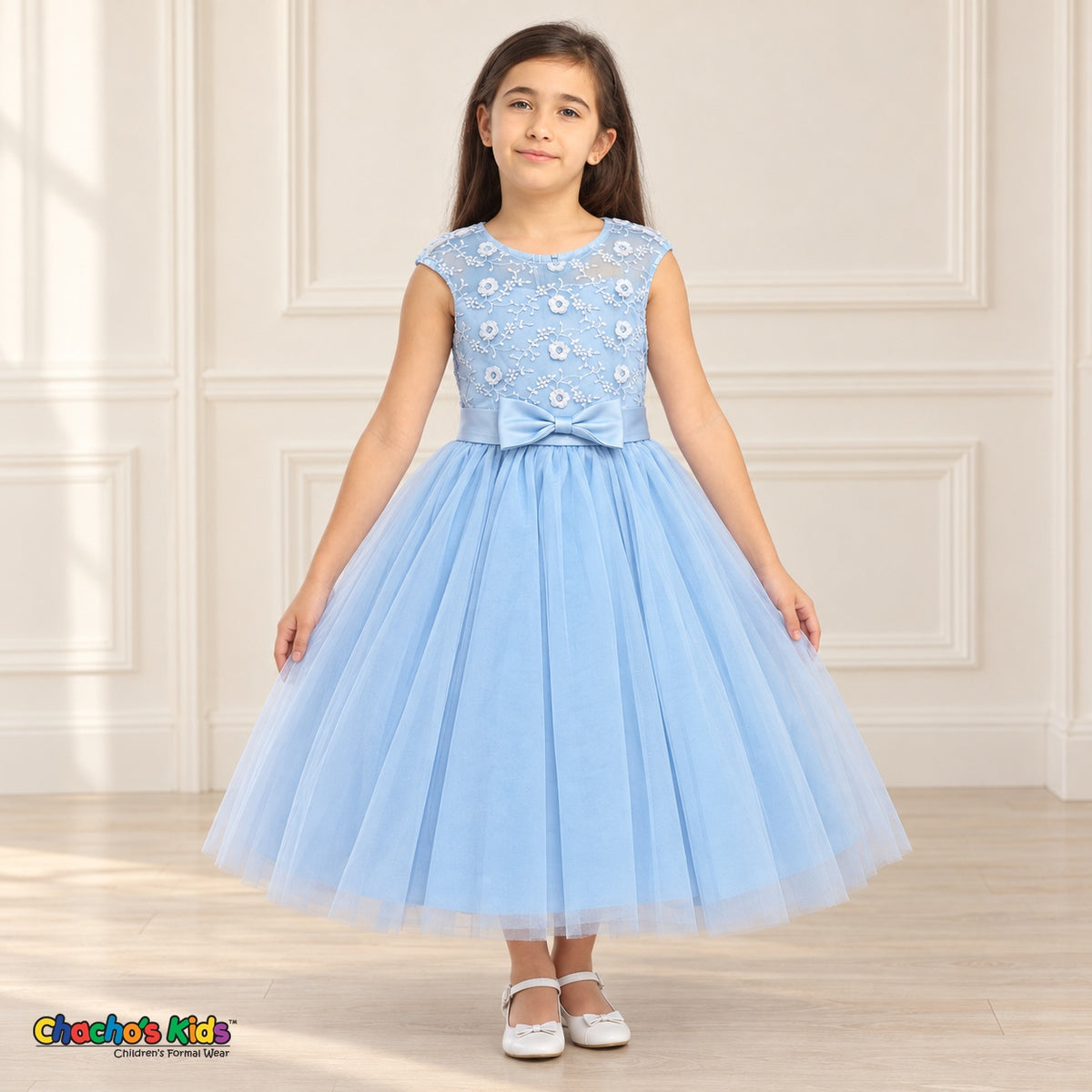 Baby Blue KE07 floral embroidered tulle dress on a child model, front view showing the sheer floral bodice, satin bow and tea-length skirt.