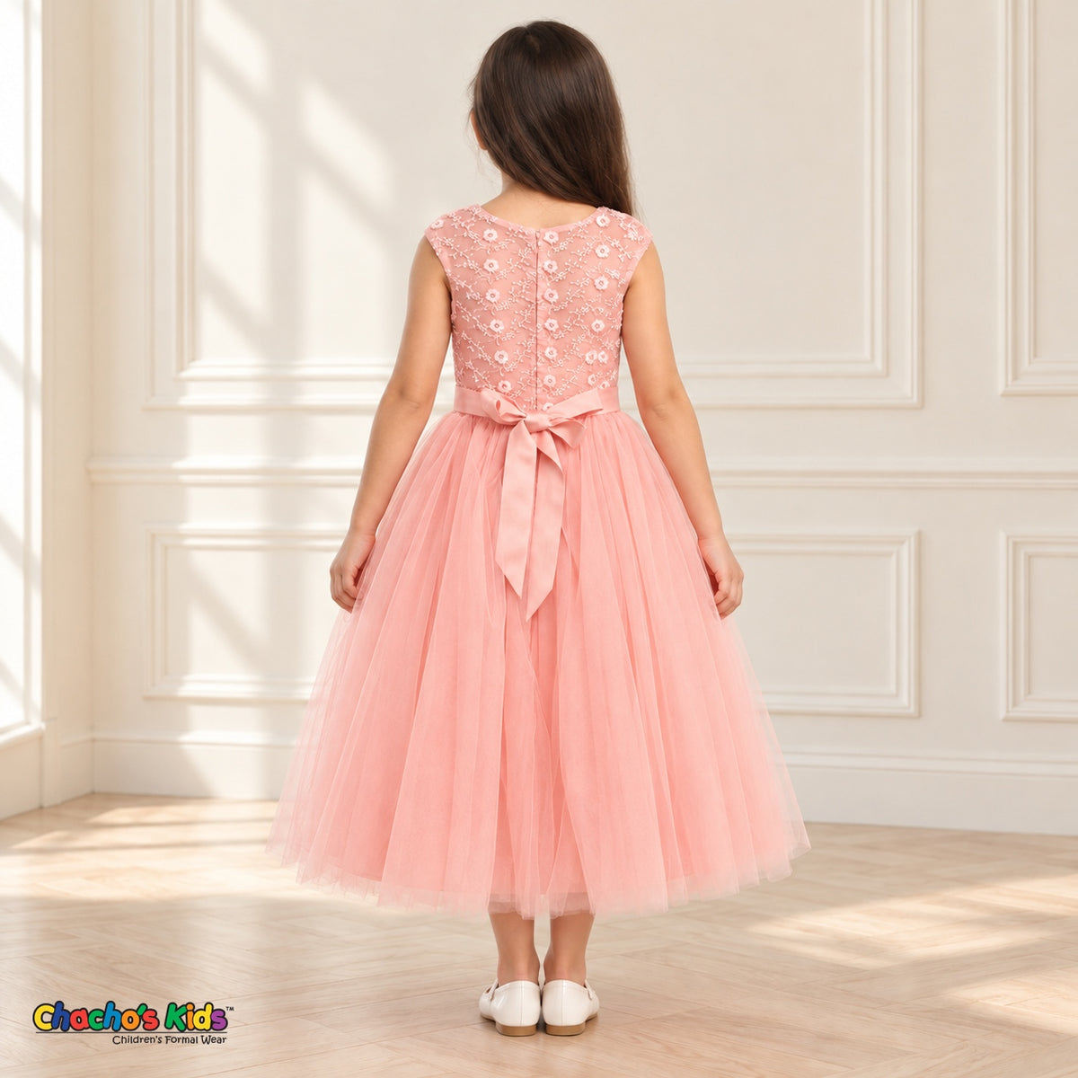 Blush KE07 floral embroidered tulle dress on the same child model, back view showing floral embroidery, zipper and satin tie-back bow.