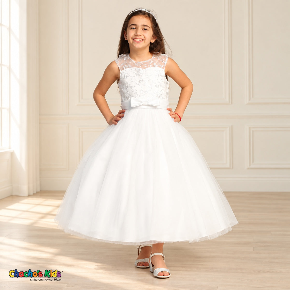 White KE07 floral embroidered tulle dress on the existing child model, smiling front view with satin waist bow.
