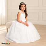 White KE07 floral embroidered tulle dress on the existing child model, seated three-quarter view showing the embroidered bodice and layered tulle skirt.
