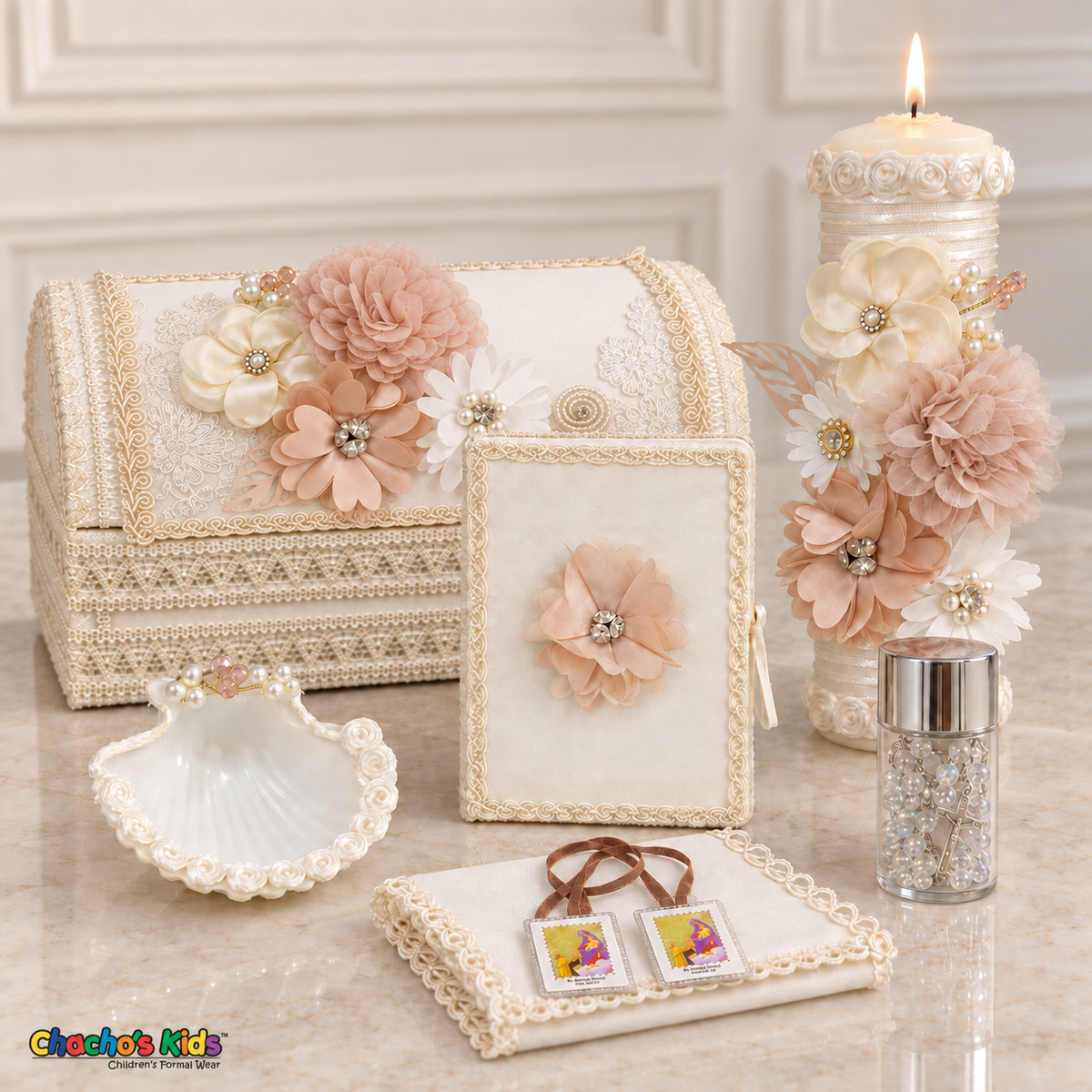 Seven-piece peach floral baptism keepsake set with a long chest, lit candle, Bible, shell, rosary, handkerchief and visible scapular.