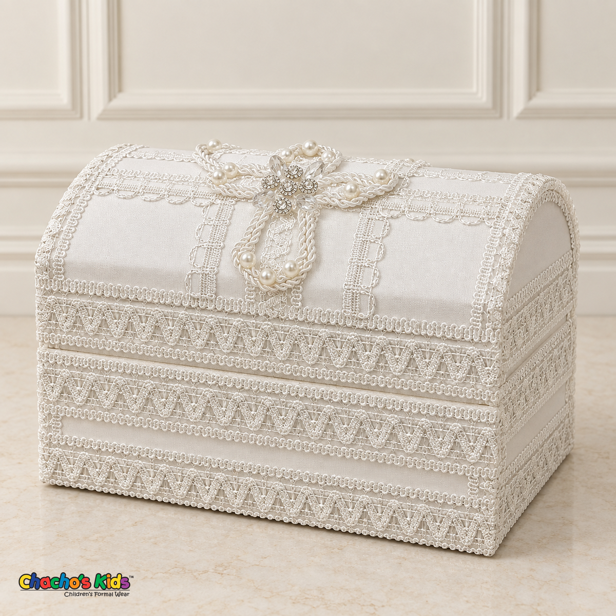 Closed ivory and white wooden baptism keepsake chest with lace bands and a pearl and crystal cross on the lid.