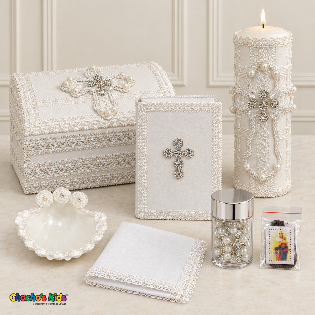 Seven-piece pearl and crystal cross boys baptism set with keepsake chest, lit candle, Bible, shell, rosary jar, scapular, and handkerchief.
