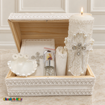 Open wooden baptism keepsake chest displaying the candle, Bible, shell, rosary jar, scapular packet, and rolled handkerchief.
