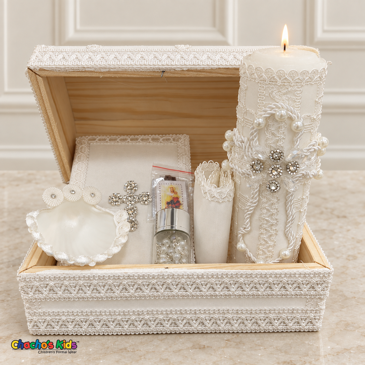 Open wooden baptism keepsake chest displaying the candle, Bible, shell, rosary jar, scapular packet, and rolled handkerchief.