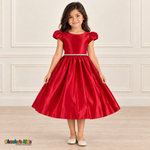 Girl wearing a red satin party dress with puff sleeves, a jeweled waist and a full gathered skirt, front view.