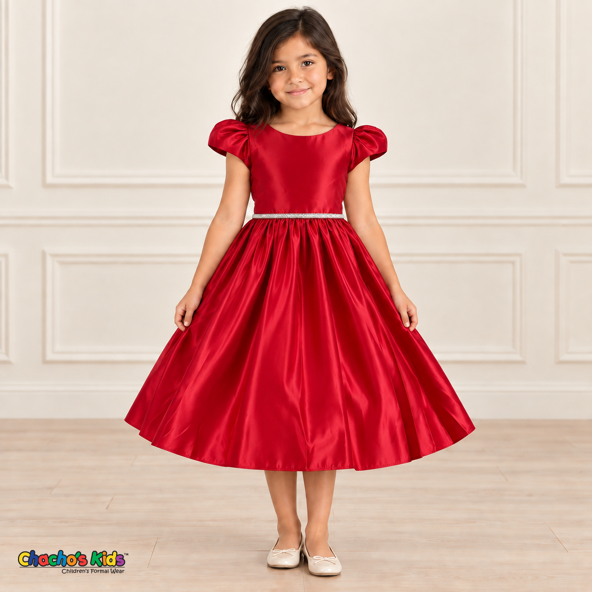 Girl wearing a red satin party dress with puff sleeves, a jeweled waist and a full gathered skirt, front view.